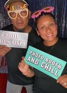 The Party Nights team posing with fun photo booth signs