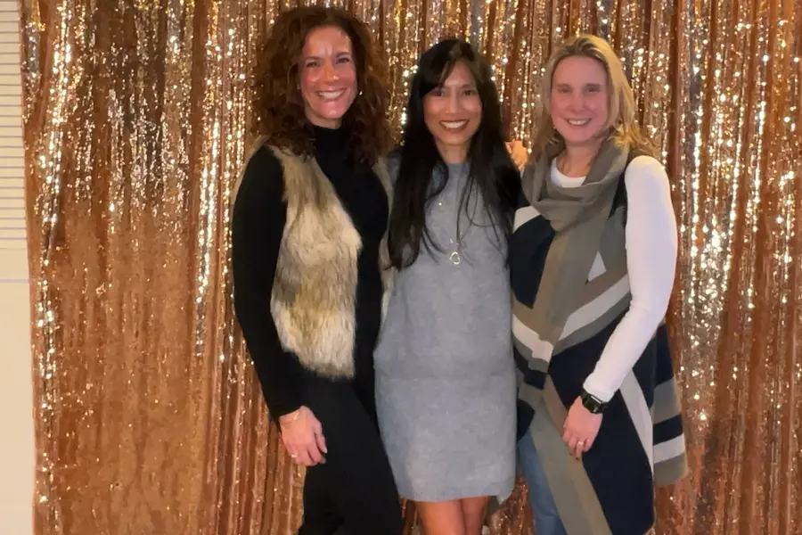 Guests smiling together at a graduation celebration