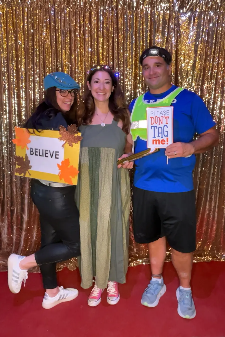 Friends posing with a handmade sign at a milestone birthday